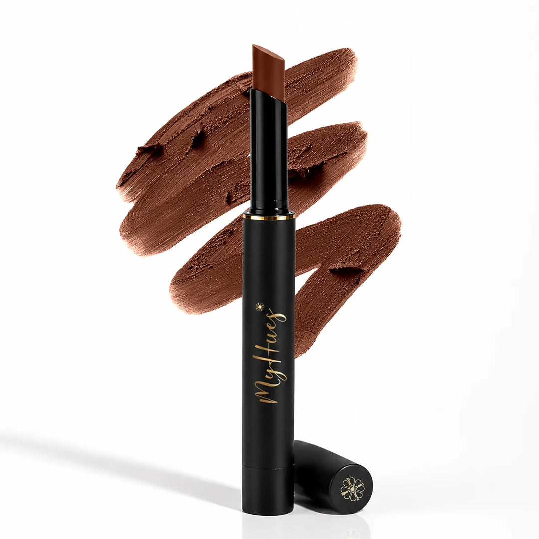 MyHues Smudgestix Mishti cool nude brown bullet lipstick displayed with creamy lipstick swatches in the background. Premium black and gold packaging showcasing a soft matte lip and cheek stick with rich pigmentation and seamless blendability for Indian skin tones.