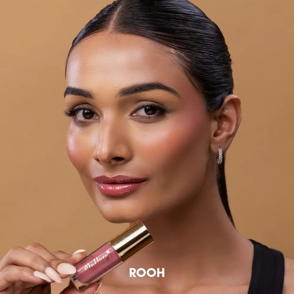 Indian model with dusky Indian skin tone wearing MyHues HyGlow Lip Elixir in Rooh, a nude pink high-shine lip gloss and lip oil hybrid. The soft nude pink shade provides rich colour payoff, juicy shine and even coverage for pigmented lips while creating a fresh everyday glossy lip look for Indian skin tones.
