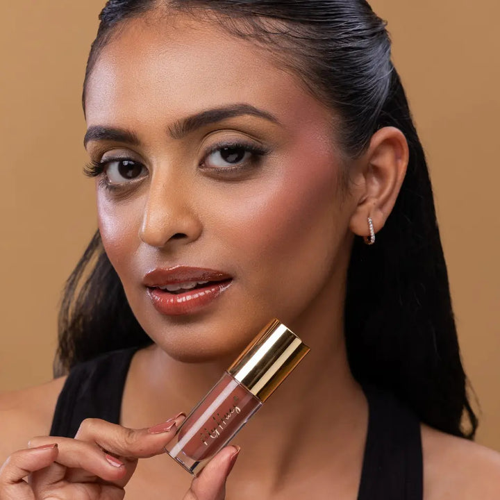 MyHues HyGlow Lip Elixir in Heer – nude brown lip gloss on deep Indian skin tone, high shine hydrating lip gloss for pigmented lips with smooth non sticky glossy finish