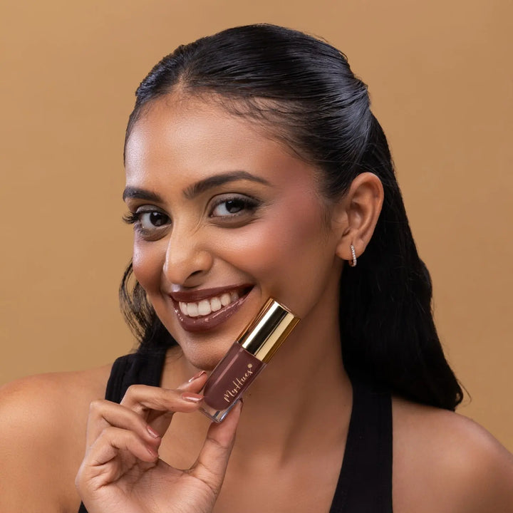 MyHues HyGlow Lip Elixir in Mira – rich brown lip gloss on deep Indian skin tone, high shine hydrating lip gloss for pigmented lips with smooth non sticky glossy finish