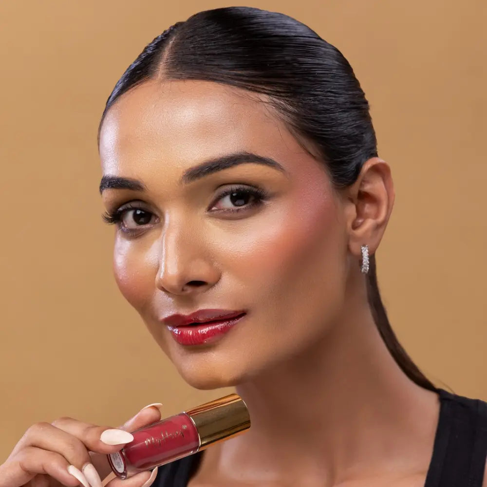 MyHues HyGlow Lip Elixir in Yana – pink lip gloss with red undertones on medium Indian skin tone, high shine hydrating lip gloss with rich pigmentation and non sticky glossy finish