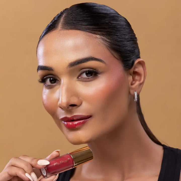 MyHues HyGlow Lip Elixir in Yana – pink lip gloss with red undertones on medium Indian skin tone, high shine hydrating lip gloss with rich pigmentation and non sticky glossy finish