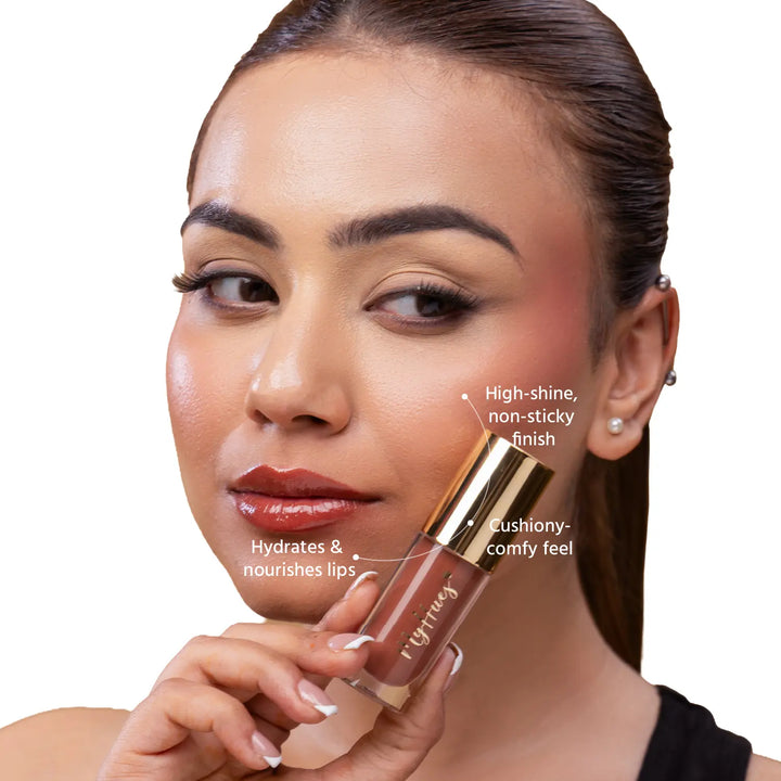 Close-up of an Indian model wearing MyHues HyGlow Lip Elixir Heer, a nude brown glossy lip oil and lip gloss hybrid. High-shine, non-sticky formula hydrates and nourishes lips while delivering a cushiony feel and rich nude brown colour that helps cover dark or pigmented lips.