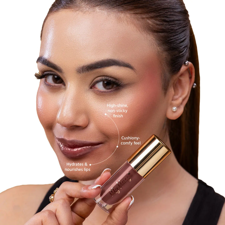 Close-up of an Indian model wearing MyHues HyGlow Lip Elixir Mira, a rich brown glossy lip oil and lip gloss hybrid. High-shine, non-sticky formula hydrates and nourishes lips while delivering a cushiony feel and rich brown colour that helps cover dark or pigmented lips.