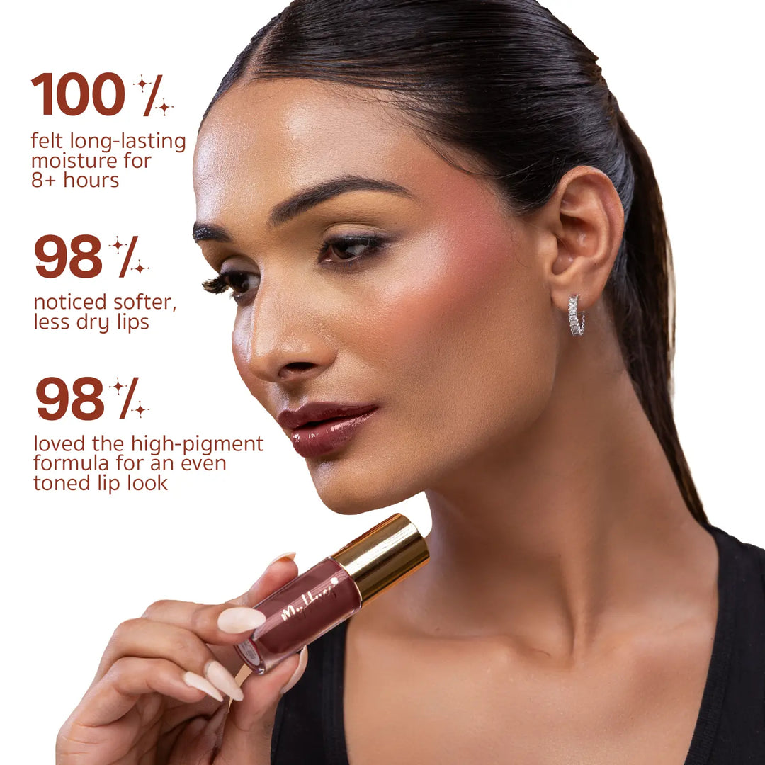 Indian model applying MyHues HyGlow Lip Elixir Mira, a rich brown high-shine lip oil and lip gloss. Consumer-tested results show 100% experienced long-lasting moisture for over 8 hours, 98% noticed softer lips, and 98% loved the highly pigmented formula for an even-toned lip look.