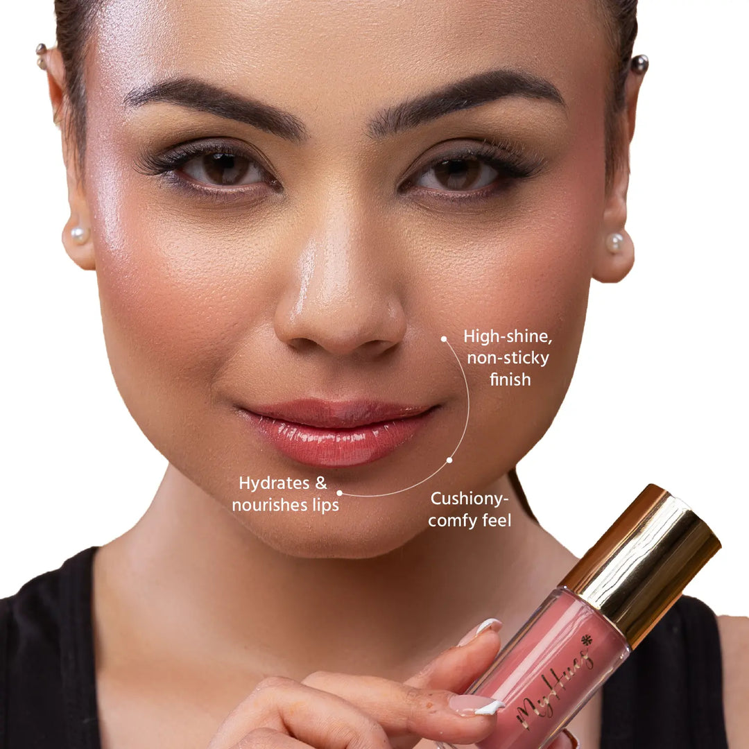 Close-up of an Indian model wearing MyHues HyGlow Lip Elixir Tara, a light nude pink glossy lip oil and lip gloss hybrid. High-shine, non-sticky formula deeply hydrates lips while delivering a fresh nude pink finish that helps even out dark or pigmented lips.