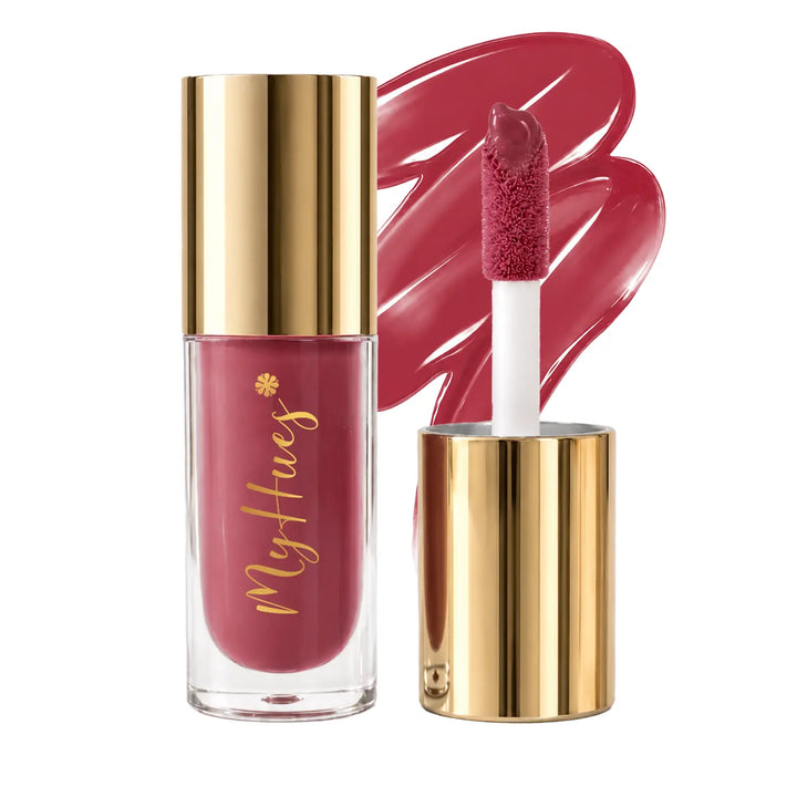 MyHues HyGlow Lip Elixir Yana warm rose pink lip oil and lip gloss featuring premium gold packaging, plush doe-foot applicator and glossy rose pink swatch. Highly pigmented lip gloss with nourishing oils provides mirror-like shine, lightweight comfort and rich colour for Indian skin tones.