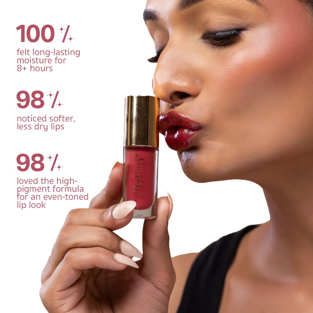 Indian model applying MyHues HyGlow Lip Elixir Yana, a warm rose pink high-shine lip oil and lip gloss. Consumer-tested results show 100% experienced long-lasting moisture for over 8 hours, 98% noticed softer lips, and 98% loved the highly pigmented formula for an even-toned lip look.